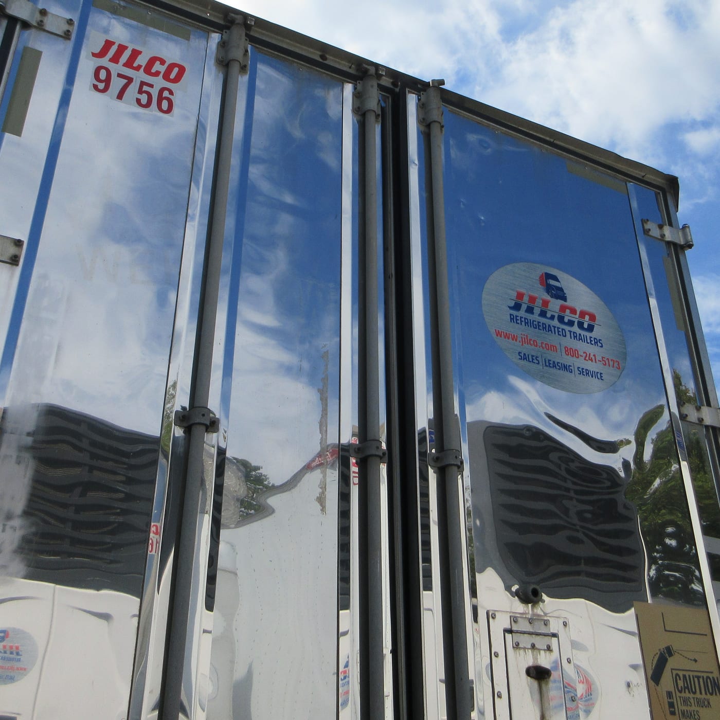The rear doors of a Jilco refrigerated trailer seen from below, the same equipment used for stationary on-site cold storage.