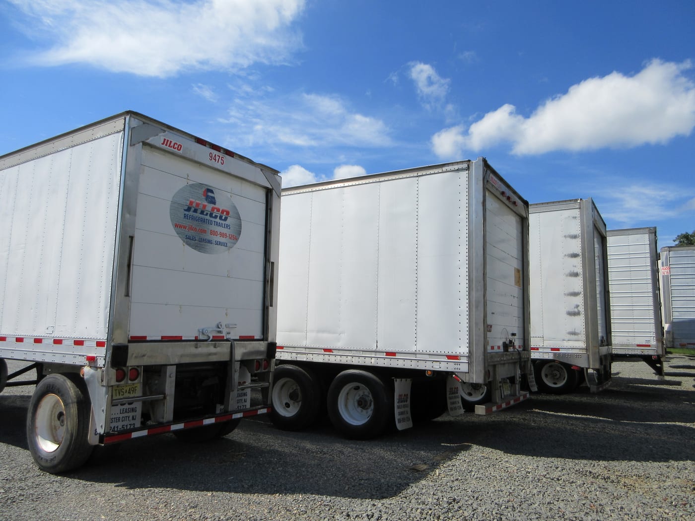 A row of Jilco trailers parked rear-first at the New Jersey yard, the kind of unit placed on site as temporary cold storage.